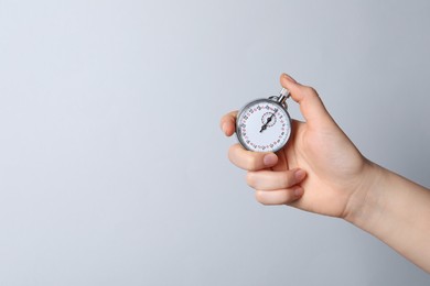 Photo of Woman holding vintage timer on white background, closeup. Space for text