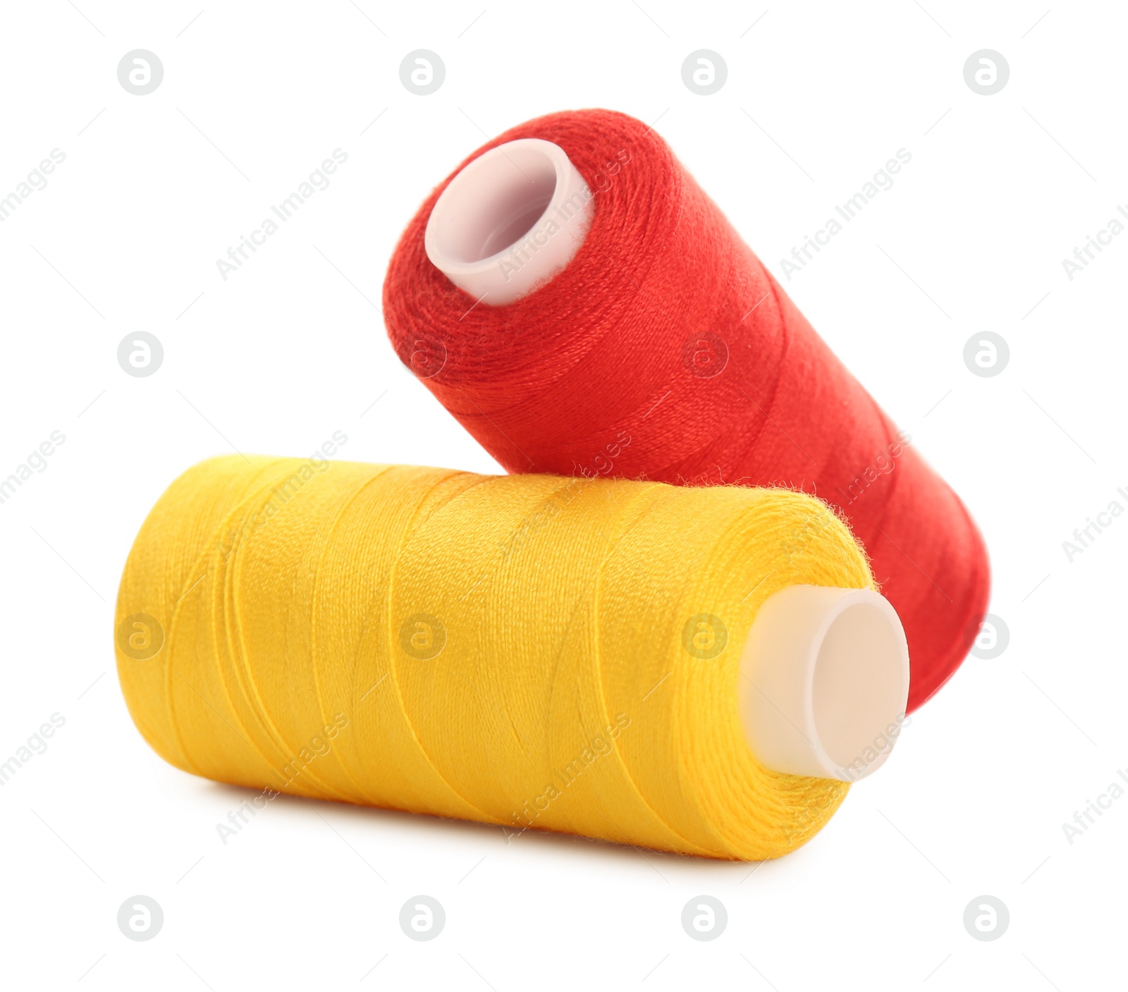 Photo of Different colorful sewing threads on white background