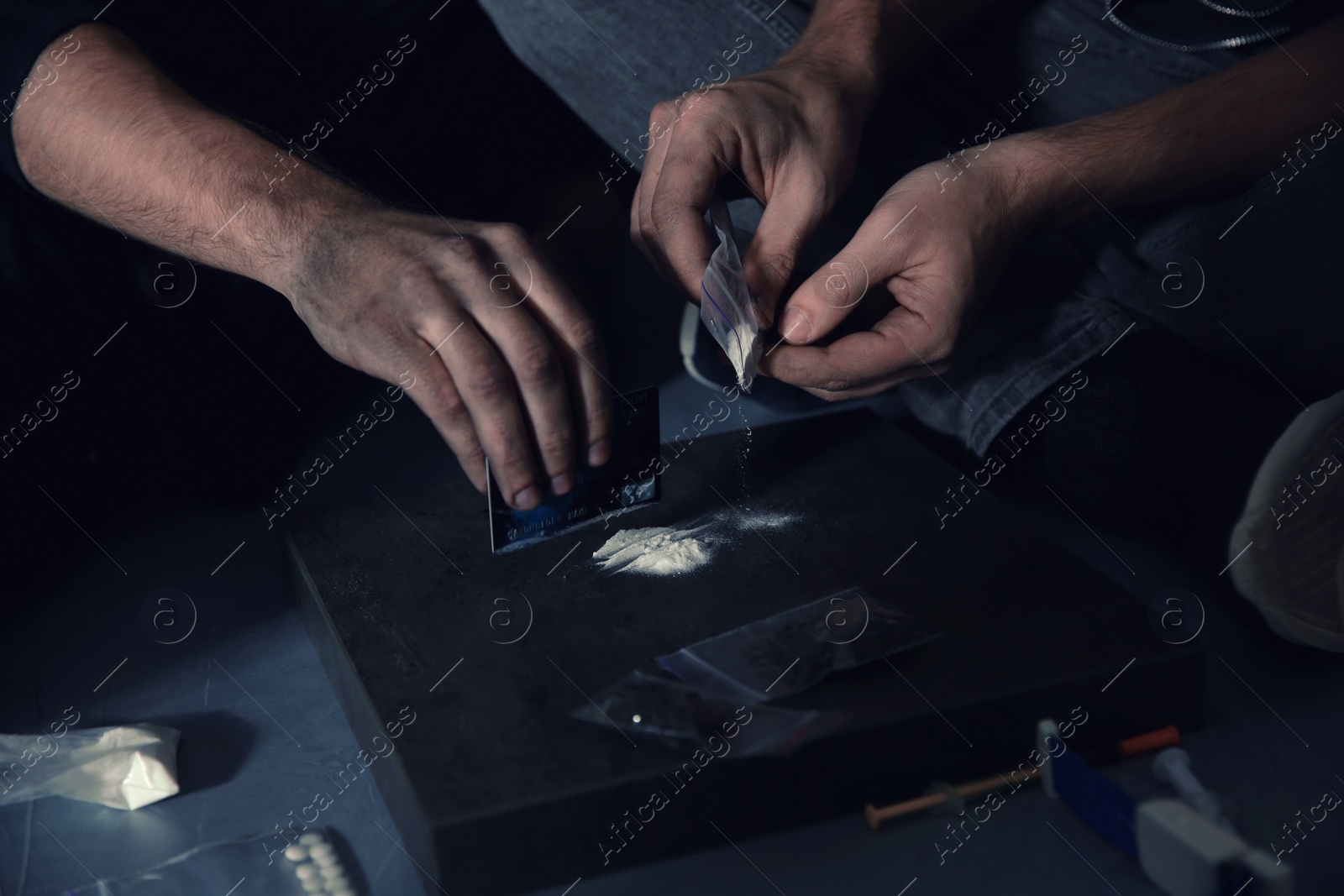 Photo of Young addicted men taking drugs, closeup of hands