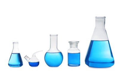 Set of laboratory glassware with blue liquid on white background