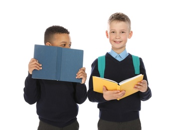 Portrait of cute children in school uniform with books on white background