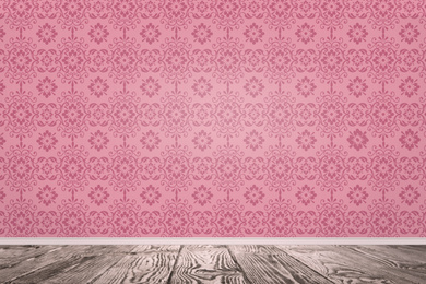 Pink wallpaper and wooden floor in room