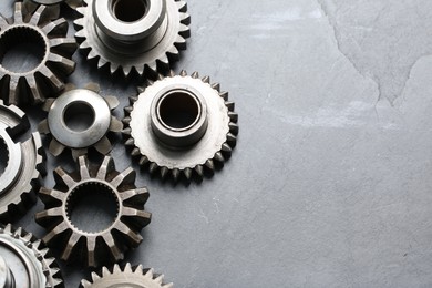 Photo of Different stainless steel gears on light grey background, above view. Space for text