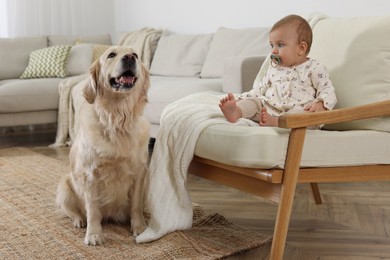 Cute little baby with adorable dog at home