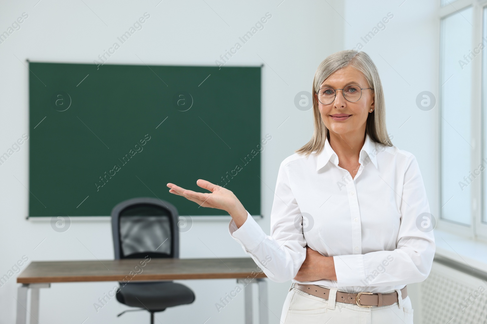 Photo of Portrait of smiling professor in classroom, space for text