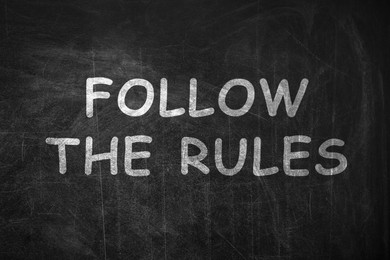 Illustration of Phrase Follow The Rules written with chalk on blackboard