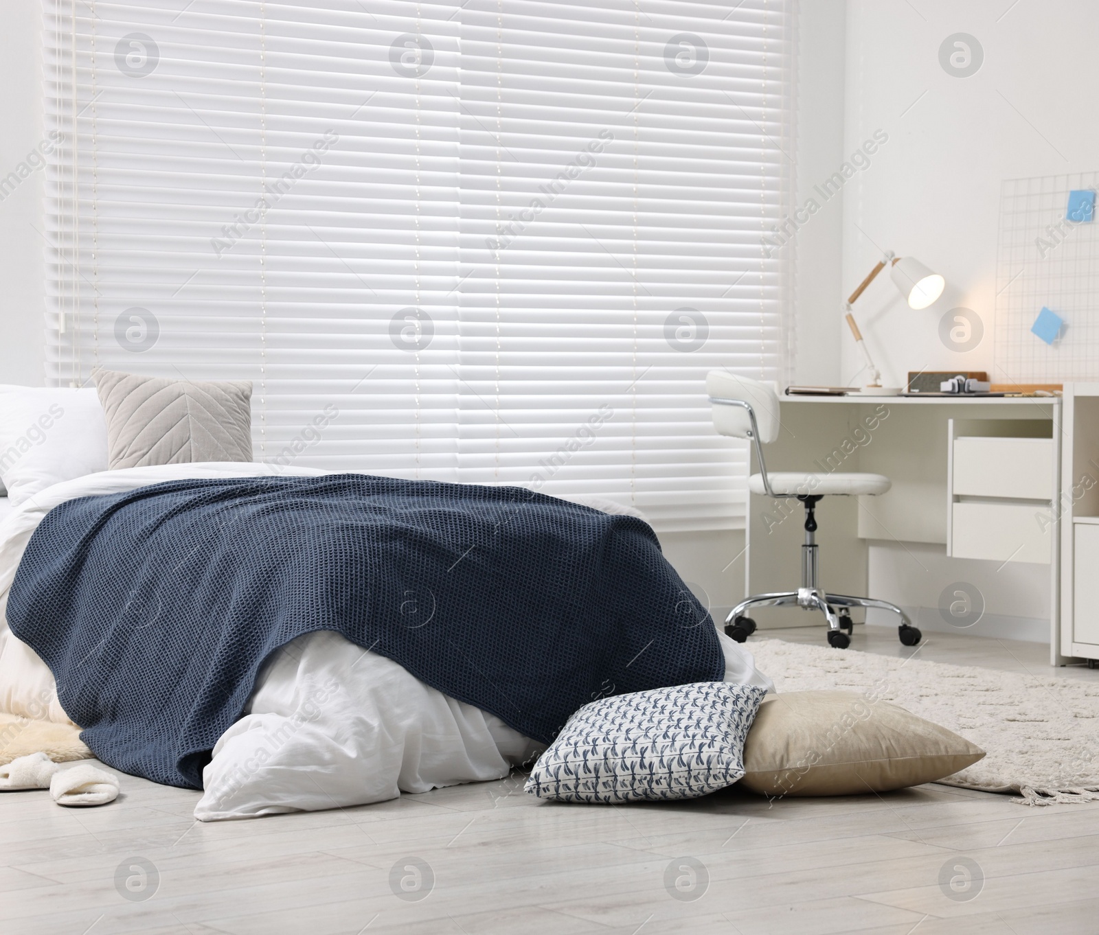 Photo of Bedroom interior with comfortable furniture, big window and white blinds