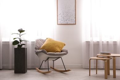 Large pot with ficus near window in room. Element of interior design