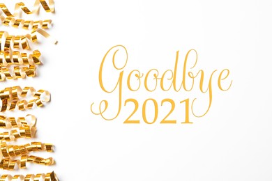 Image of Shiny golden serpentine streamers and phrase Goodbye 2021 on white background, top view