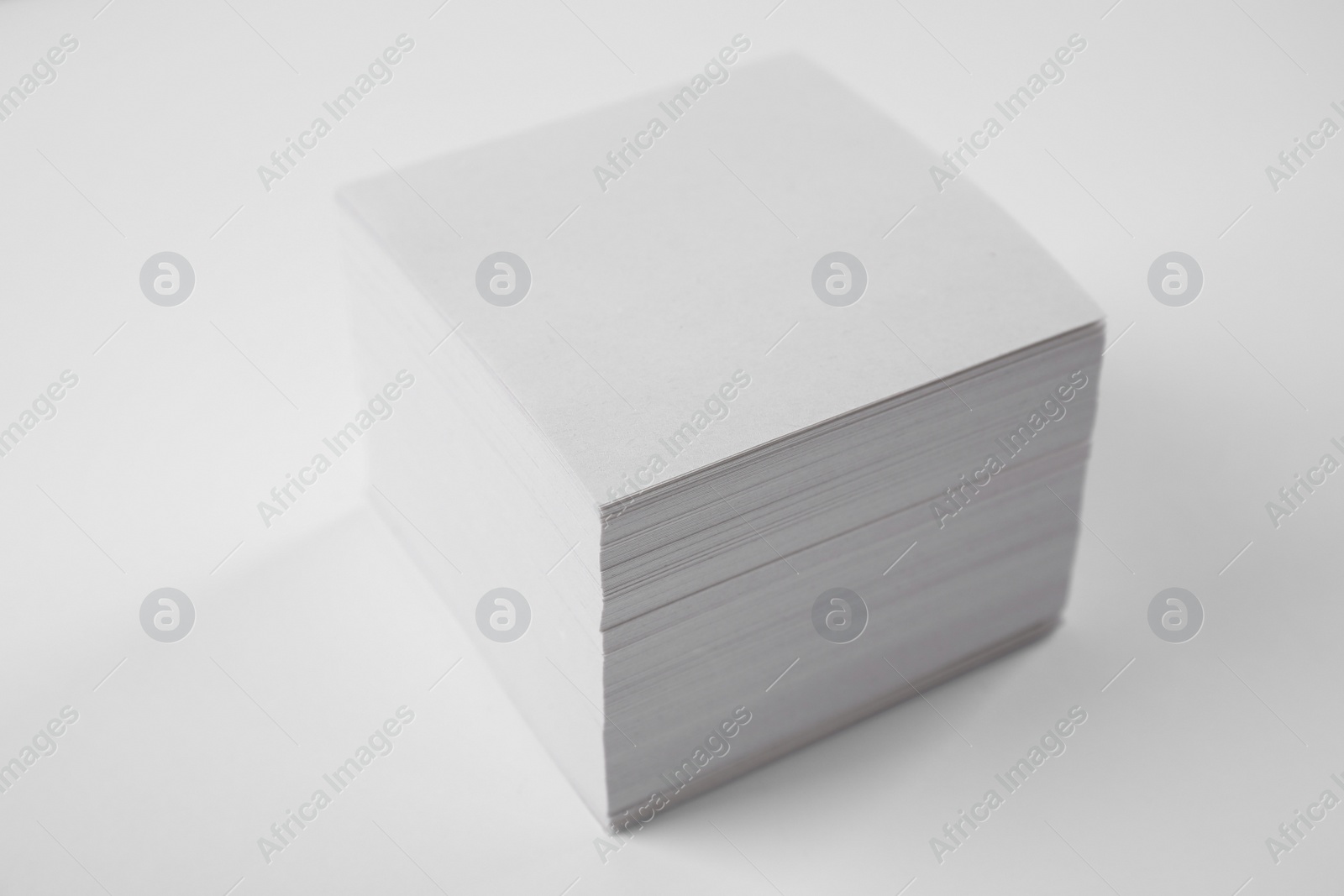 Photo of Stack of blank memory note papers on white background. Mock up for design