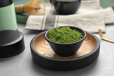 Photo of Bowl with powdered matcha tea on table