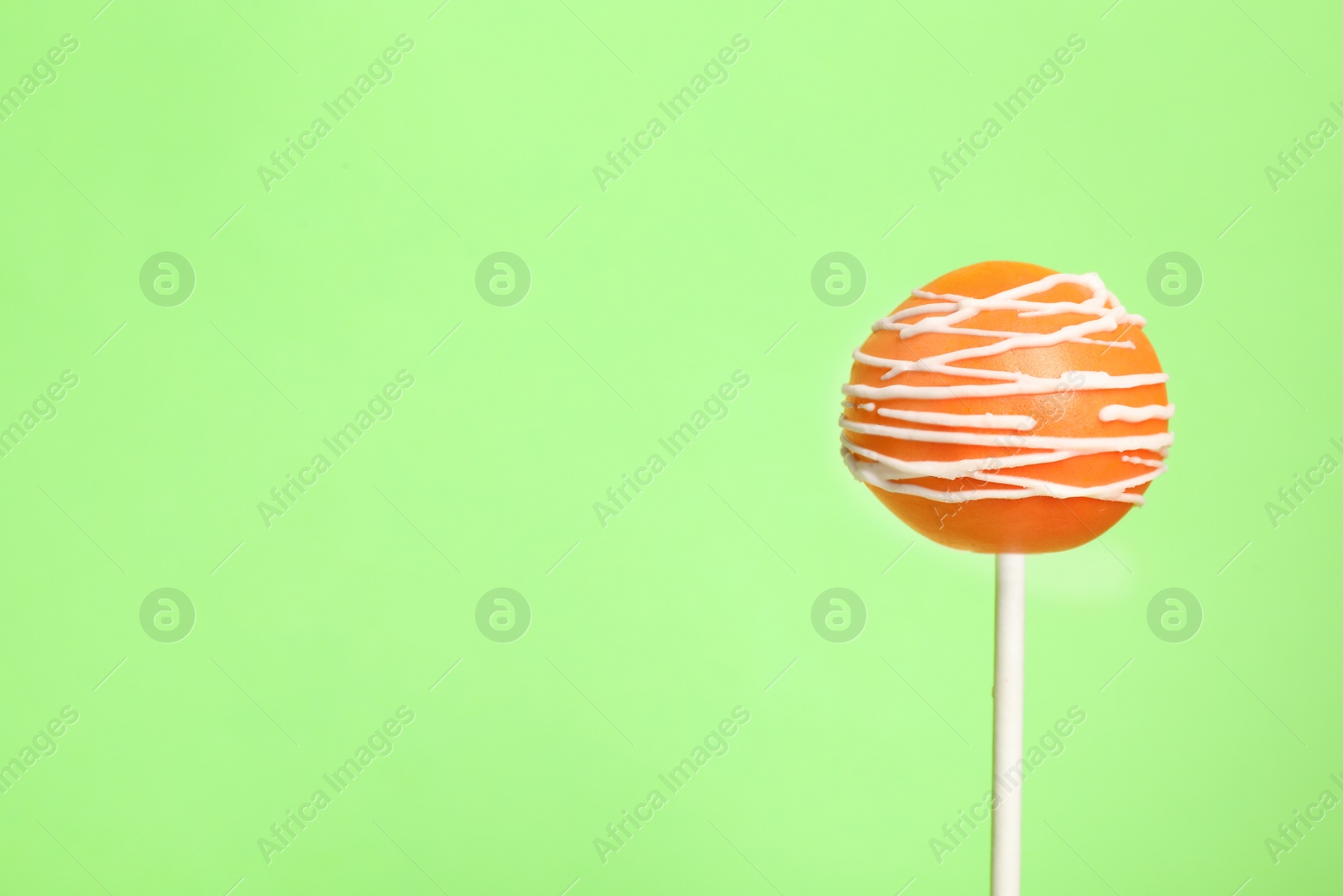 Photo of Bright delicious cake pop on color background. Space for text