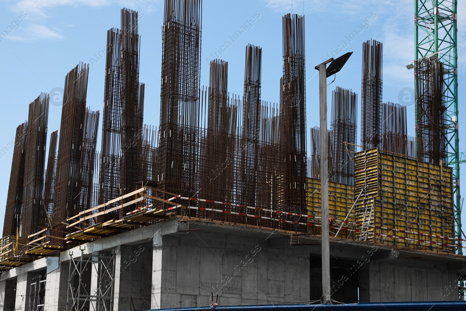 Photo of Building under construction against blue sky on sunny day