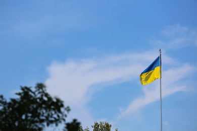 Photo of National flag of Ukraine against blue sky