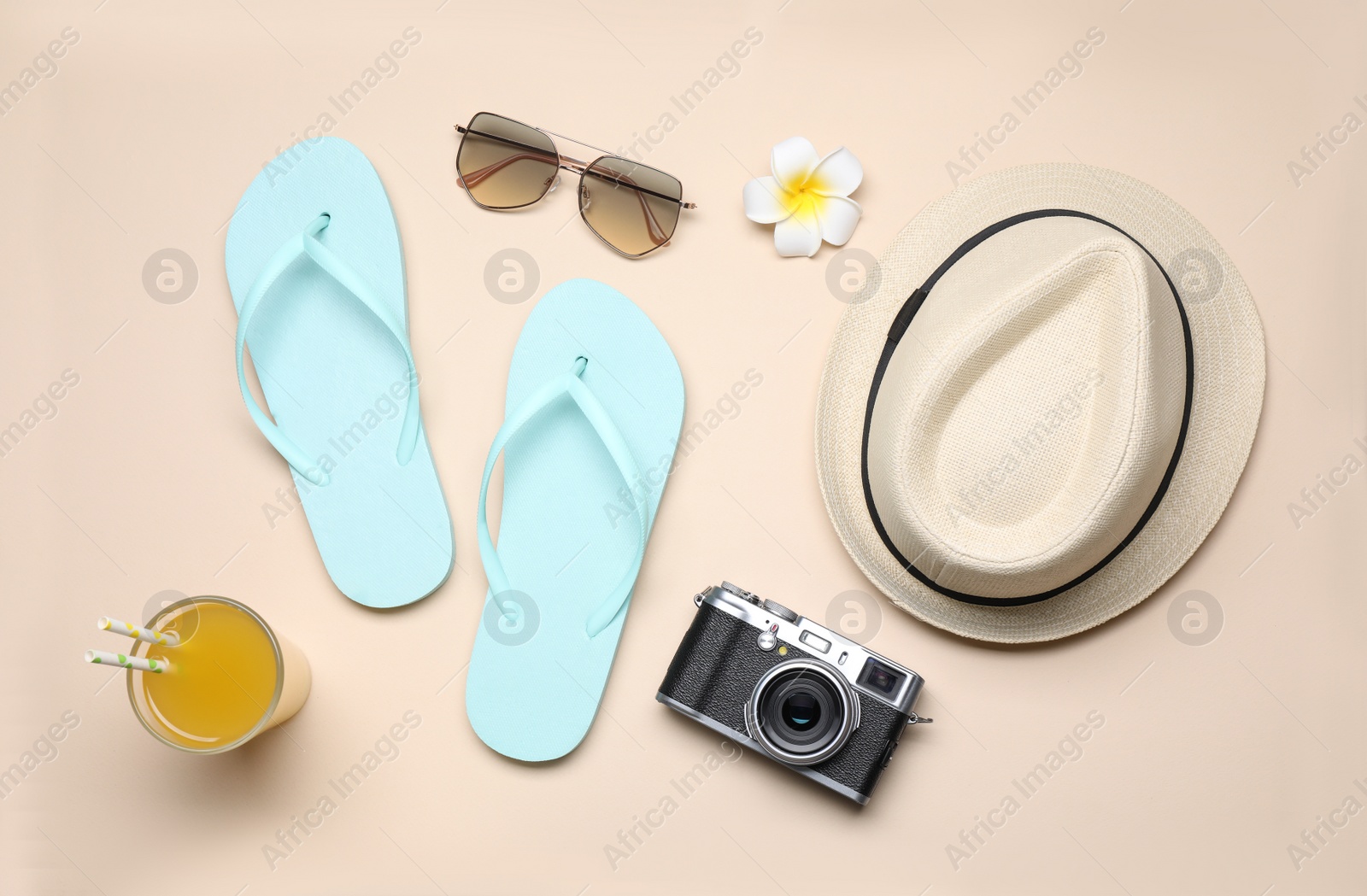 Photo of Beach accessories on beige background, flat lay