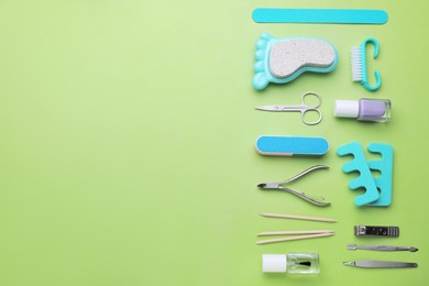 Photo of Setpedicure tools on light green background, flat lay. Space for text