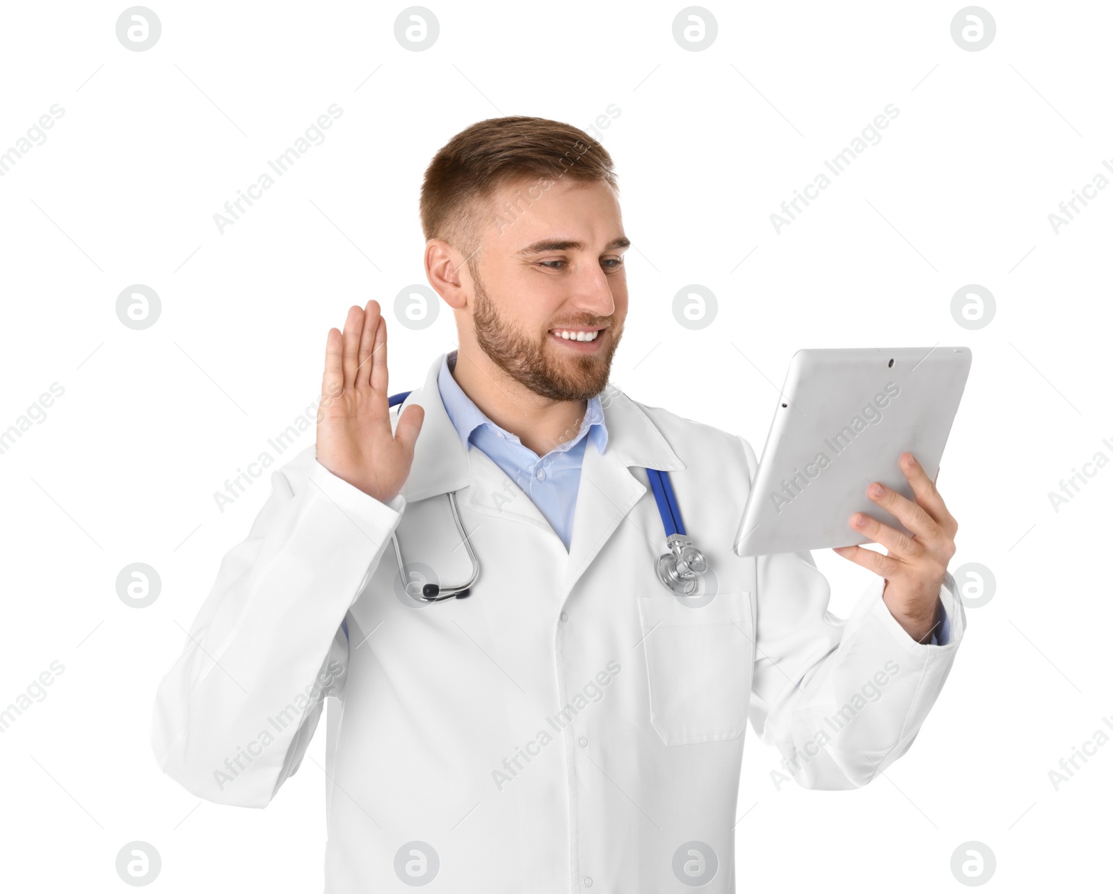 Photo of Male doctor using video chat on tablet against white background