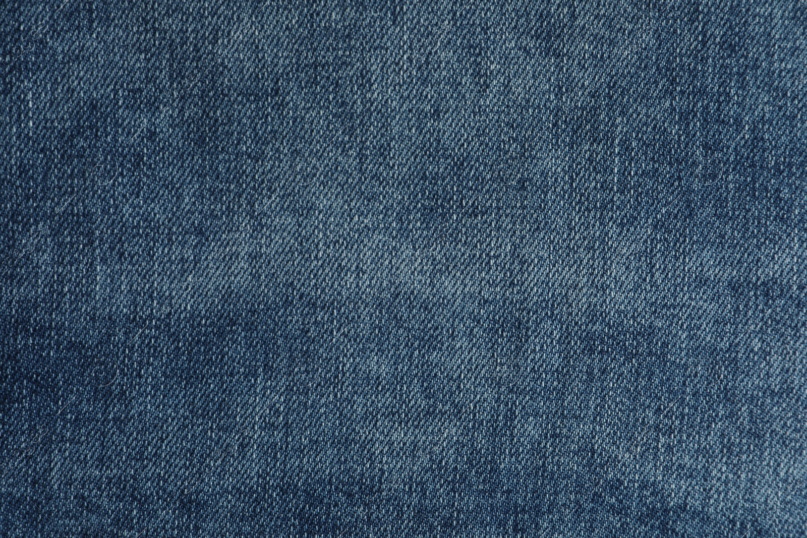 Photo of Texture of dark blue jeans as background, closeup