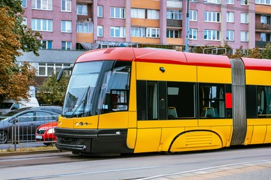 Photo of Modern tram on city street. Public transport