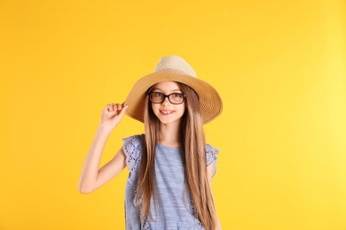 Photo of Portrait of cute little girl on yellow background