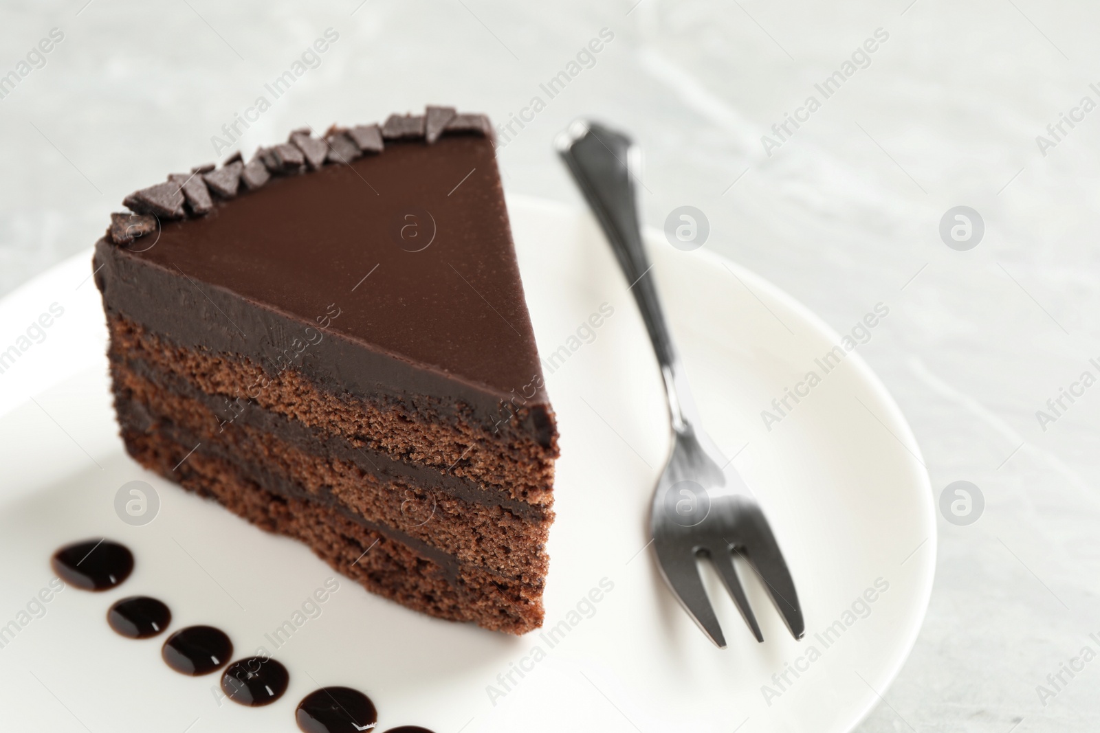 Photo of Piece of tasty chocolate cake served on plate