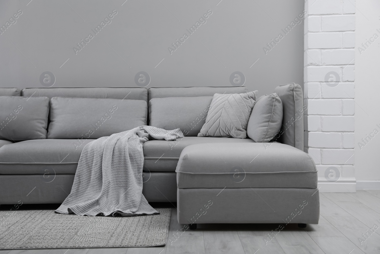 Photo of Large grey sofa in living room. Interior design