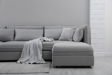 Large grey sofa in living room. Interior design