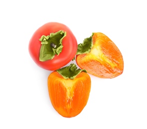 Photo of Delicious cut and whole fresh persimmons isolated on white, top view