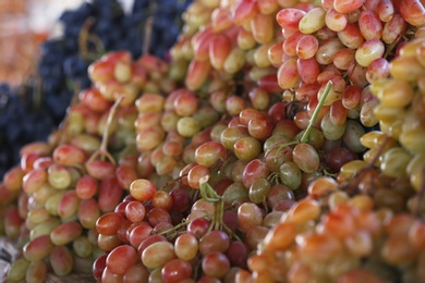 Photo of Fresh ripe juicy grapes on blurred background, closeup