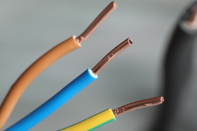 Colorful electrical wires on blurred background, closeup