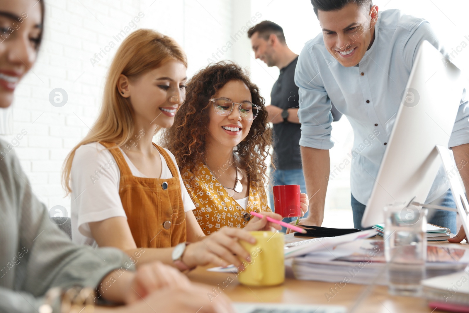 Photo of Team of professional designers working in office