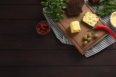 Photo of Tasty butter, bread and other ingredients on wooden table, top view. Space for text