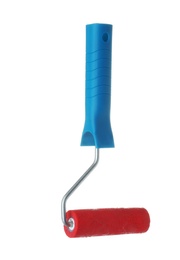 Photo of Roller brush with red paint on white background