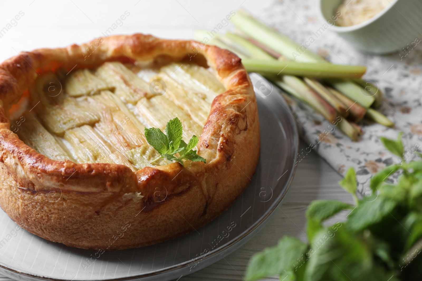 Photo of Freshly baked rhubarb pie on white wooden table, closeup