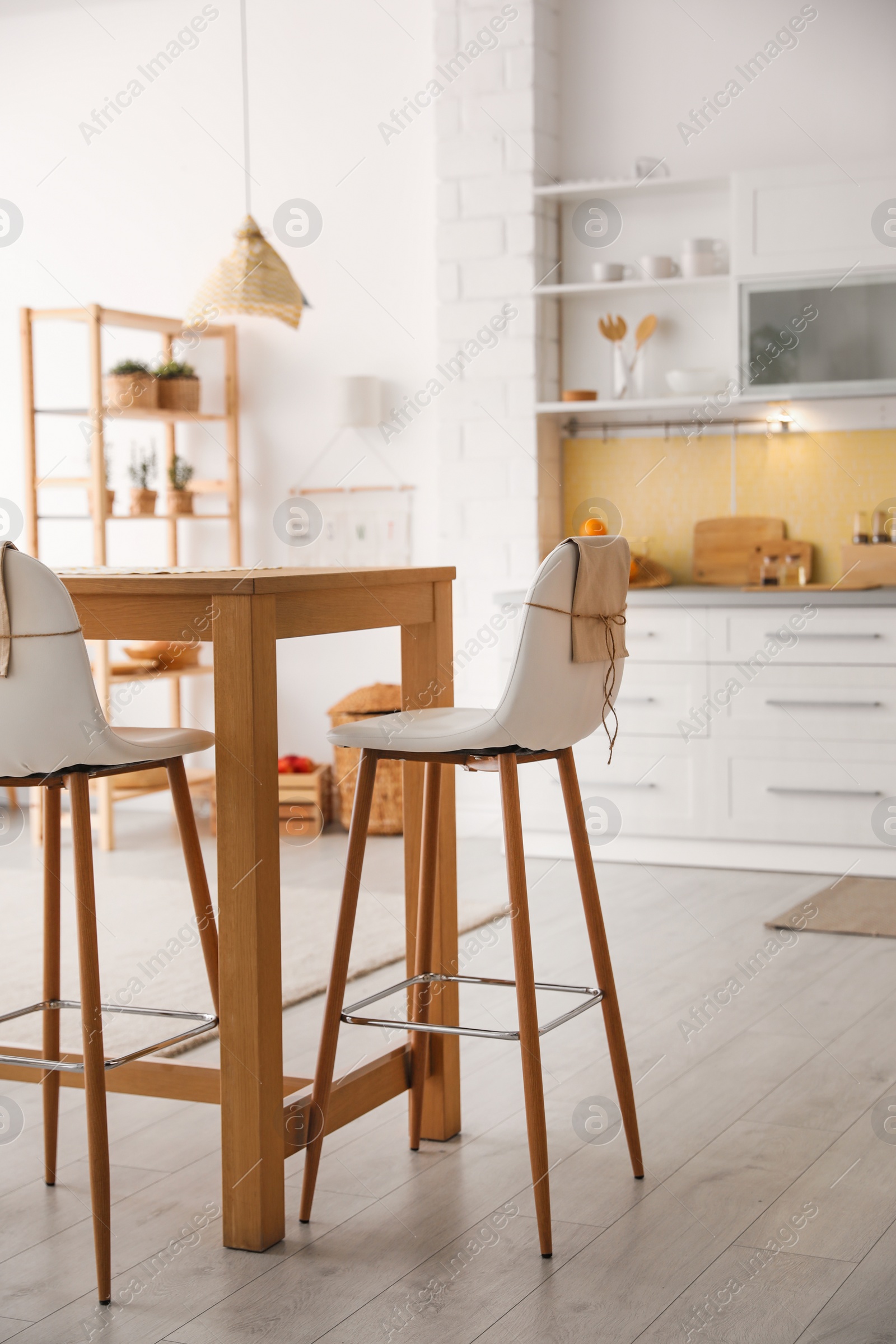 Photo of Modern kitchen interior with stylish wooden table