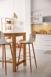 Modern kitchen interior with stylish wooden table