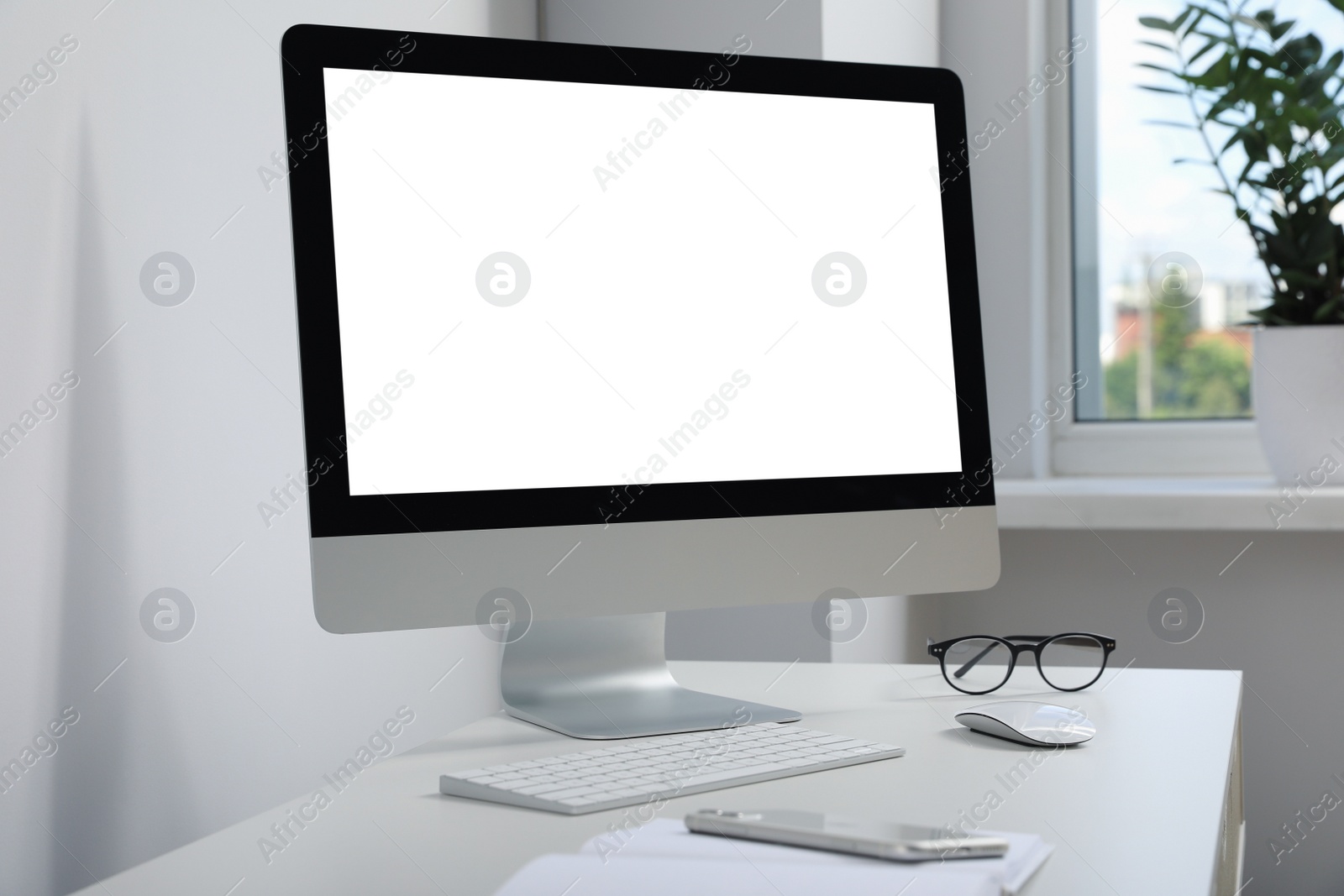 Photo of Workplace with modern computer and smartphone on white table. Mockup for design