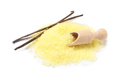 Photo of Yellow sea salt, vanilla pods and scoop isolated on white