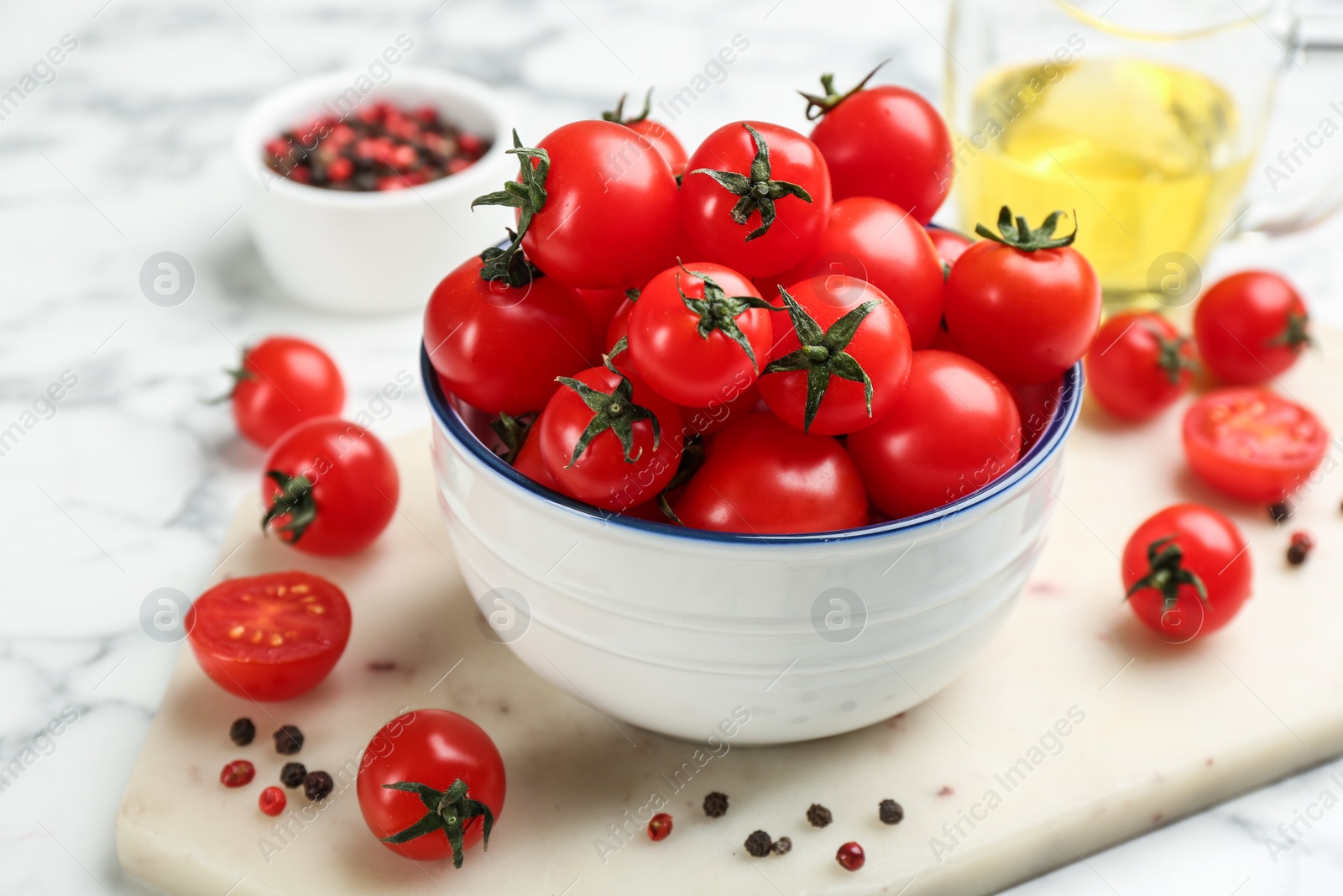 Photo of Fresh cherry tomatoes on white marble table