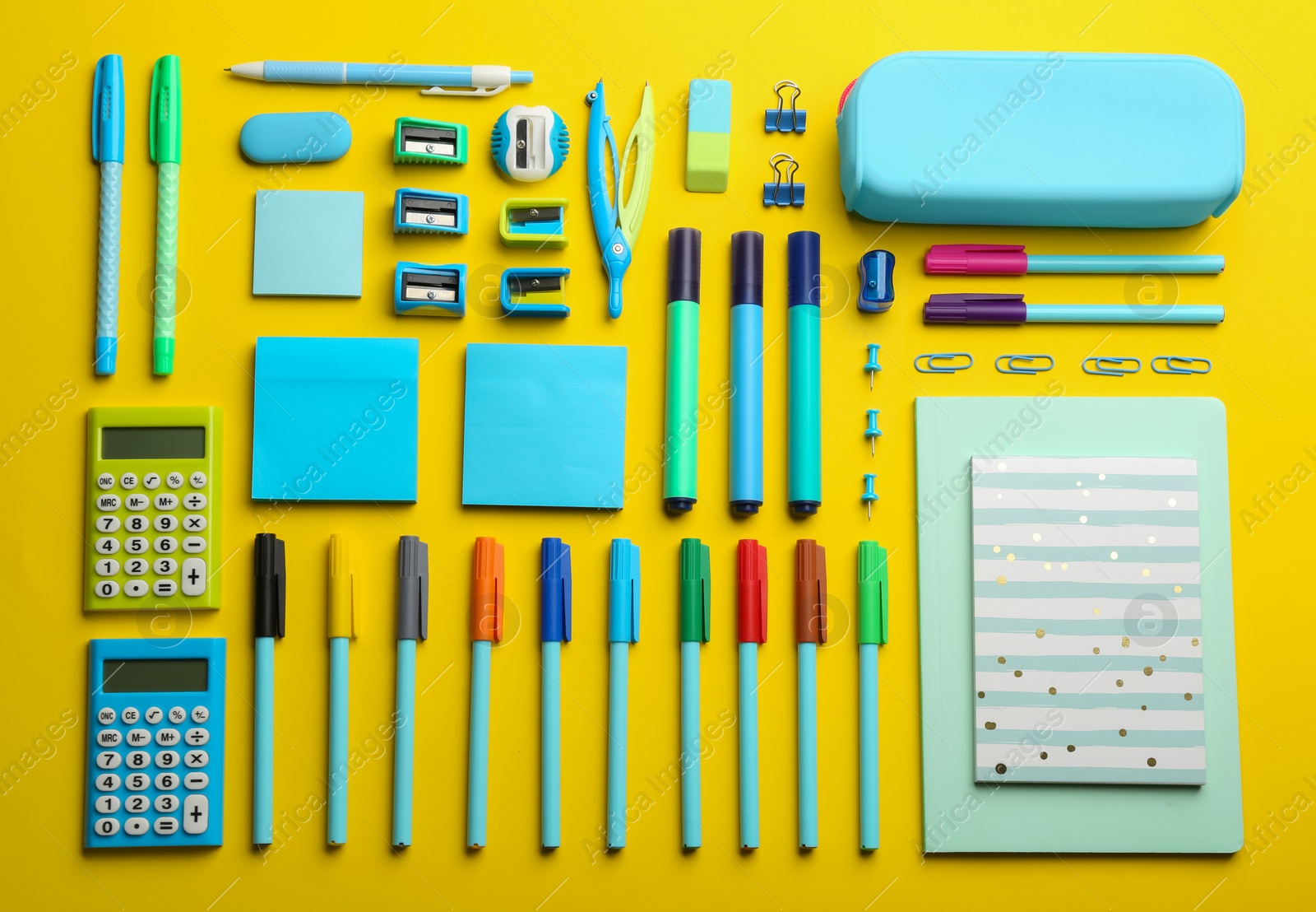 Photo of Flat lay composition with school stationery on yellow background. Back to school