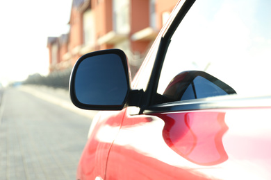 Side rear view mirror of modern car outdoors