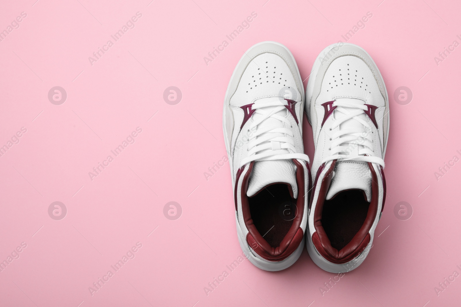 Photo of Pair of stylish shoes on pink background, top view. Space for text