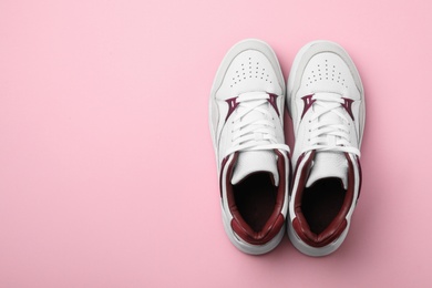 Photo of Pair of stylish shoes on pink background, top view. Space for text