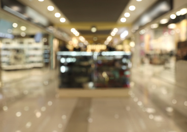 Photo of Blurred view of modern shopping mall interior. Bokeh effect