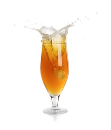 Photo of Beer splashing out of glass on white background