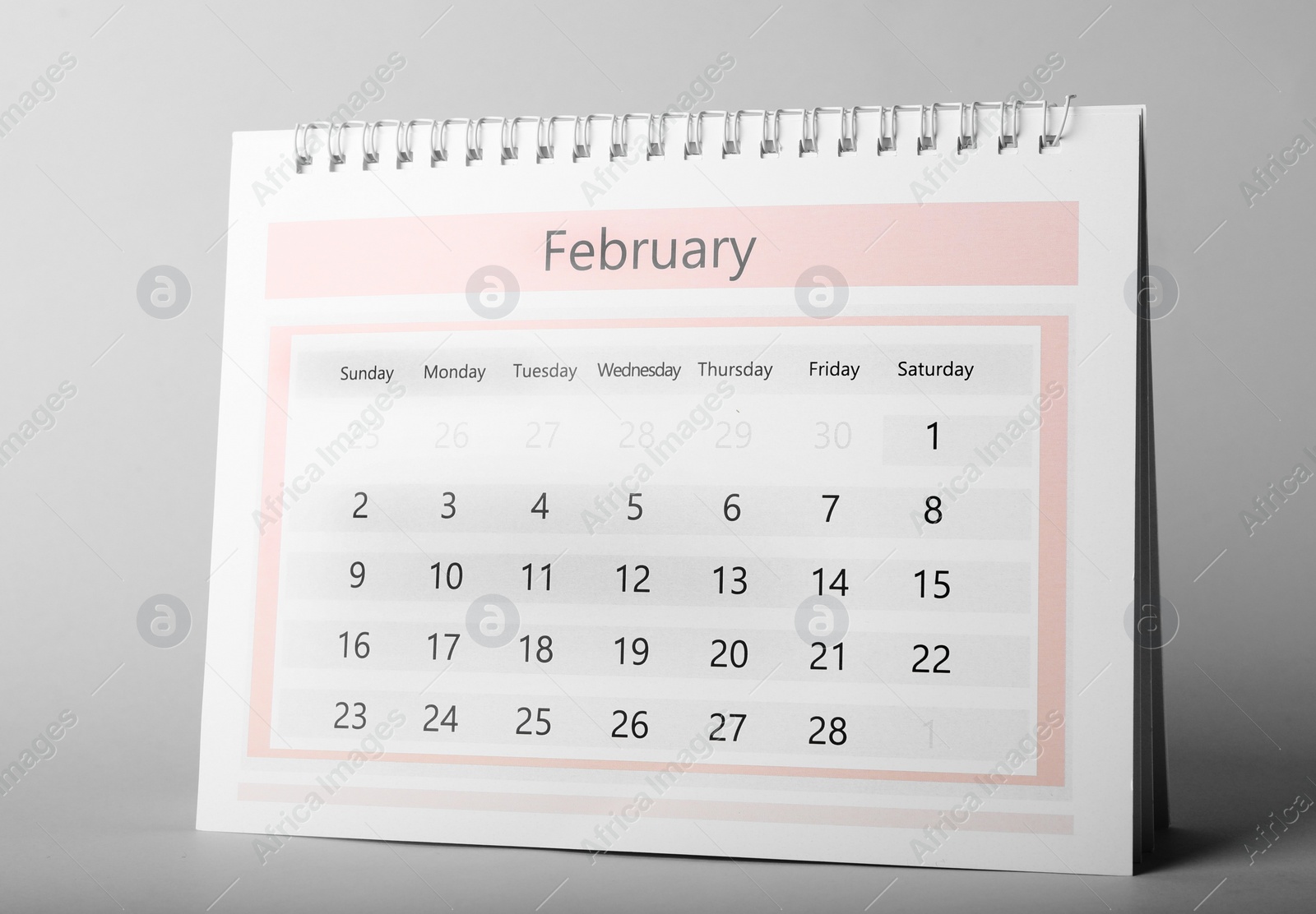 Photo of Paper calendar on grey background. Planning concept