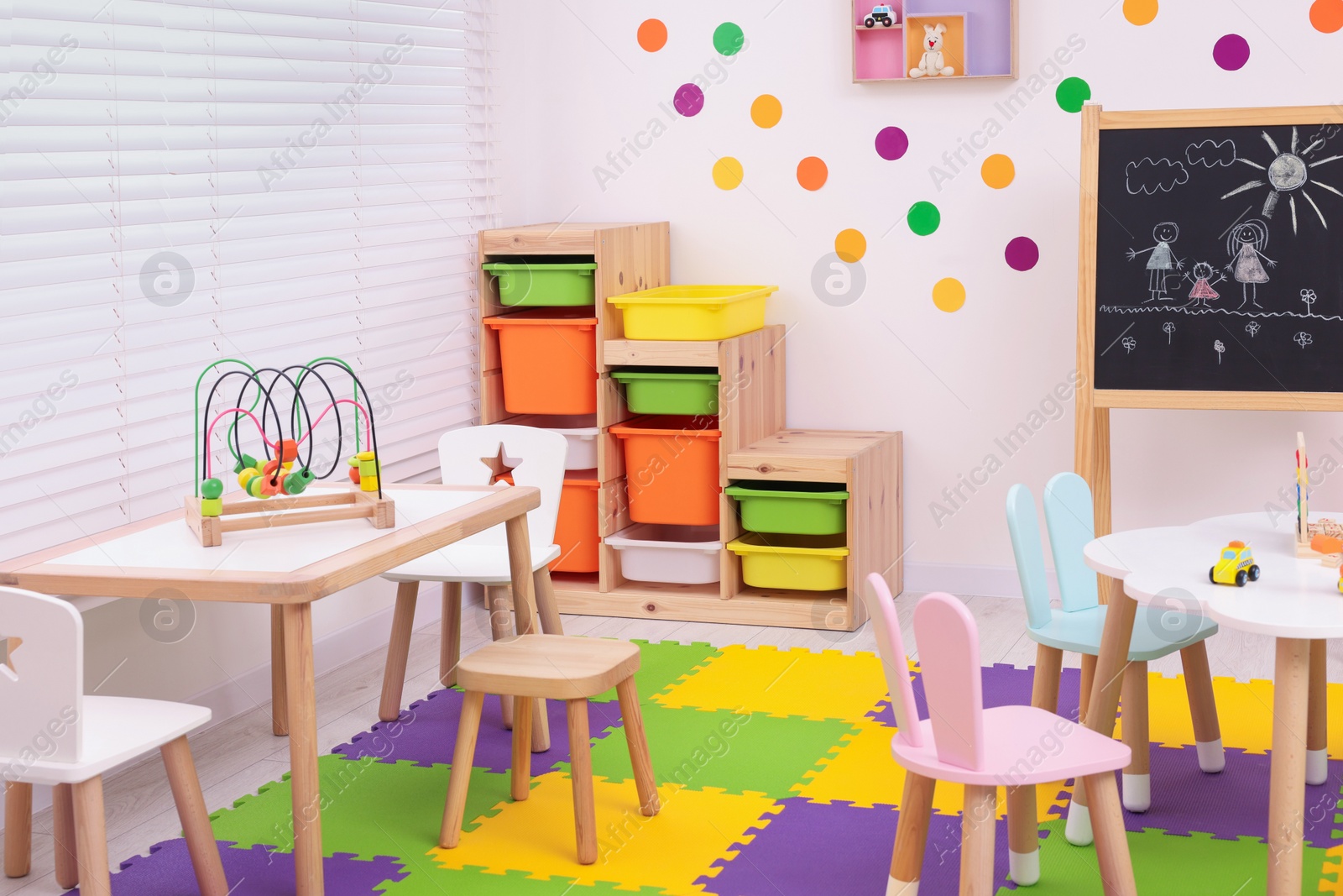 Photo of Stylish kindergarten interior with toys and modern furniture