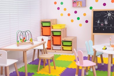 Stylish kindergarten interior with toys and modern furniture