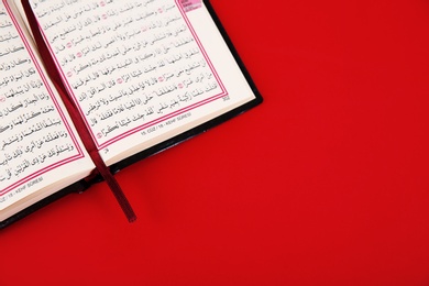 Photo of Quran and space for text on color background, top view. Muslim tradition