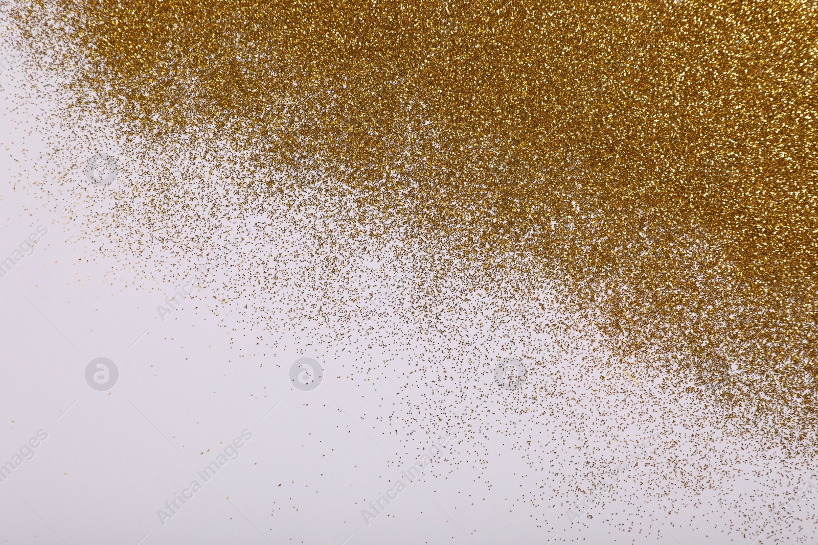 Photo of Shiny golden glitter on white background, top view